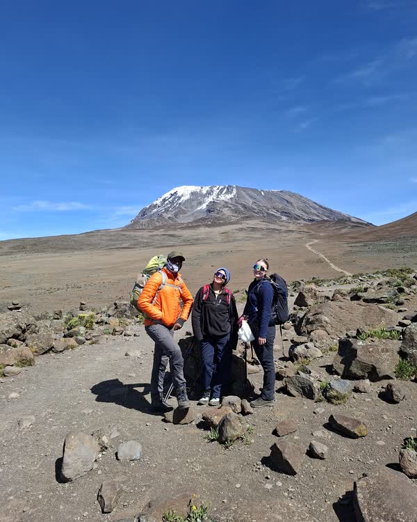 Crossing the saddle toward Kibo Hut on the Marangu route, the summit cone of Kibo ahead before the midnight push.