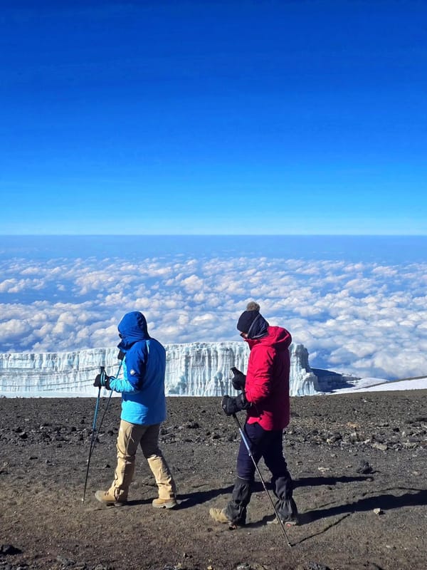 Walking past the glacier wall on the summit, above the cloud sea.