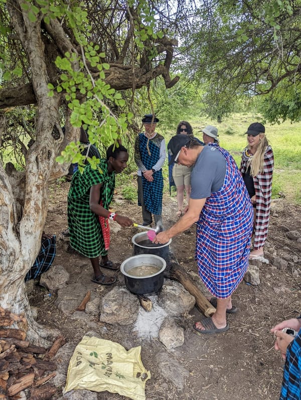 Cooking together with a Maasai family during a cultural visit.