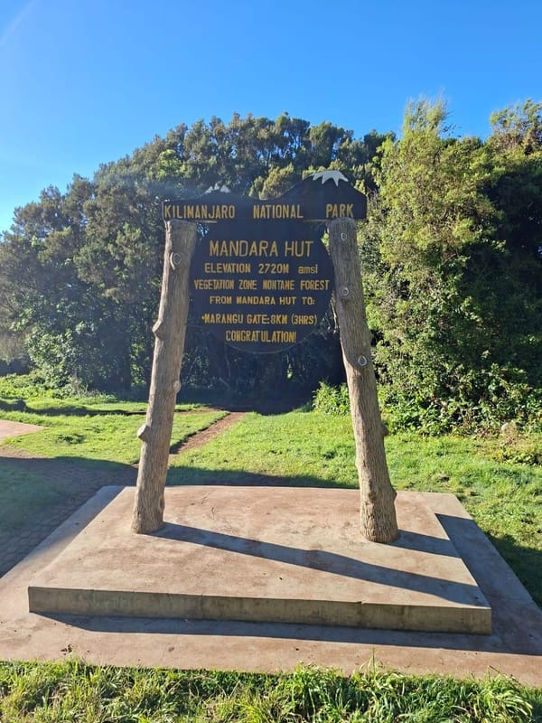 Mandara Hut welcome sign at 2,720 m on the Marangu Route.