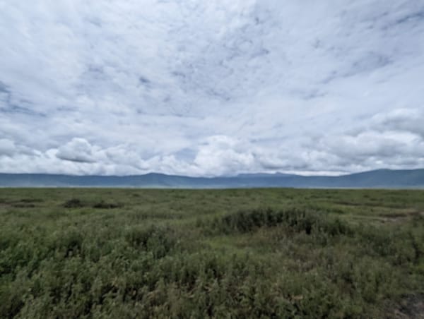 The Ngorongoro crater floor opens out under heavy cloud.