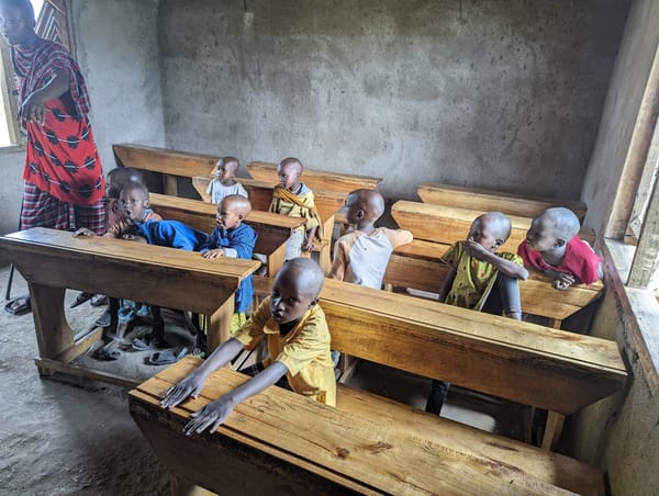 Maasai children at a village classroom, mid-lesson.